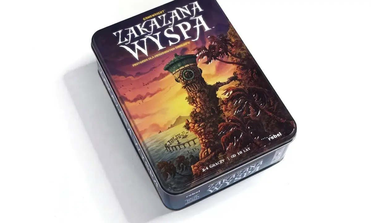 Pudełko gry planszowej "Zakazana Wyspa" z wieżą zegarową i palmami na tle zachodzącego słońca.