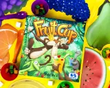 Gra Fruit Cup z owocami i kostkami. Małpa w koronie miesza owocowy deser.