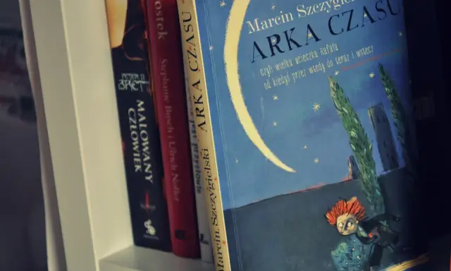 Książka "Arka Czasu" Marcina Szczygielskiego na półce. Ilustracja przedstawia nocne niebo z księżycem i biegnącą postacią.