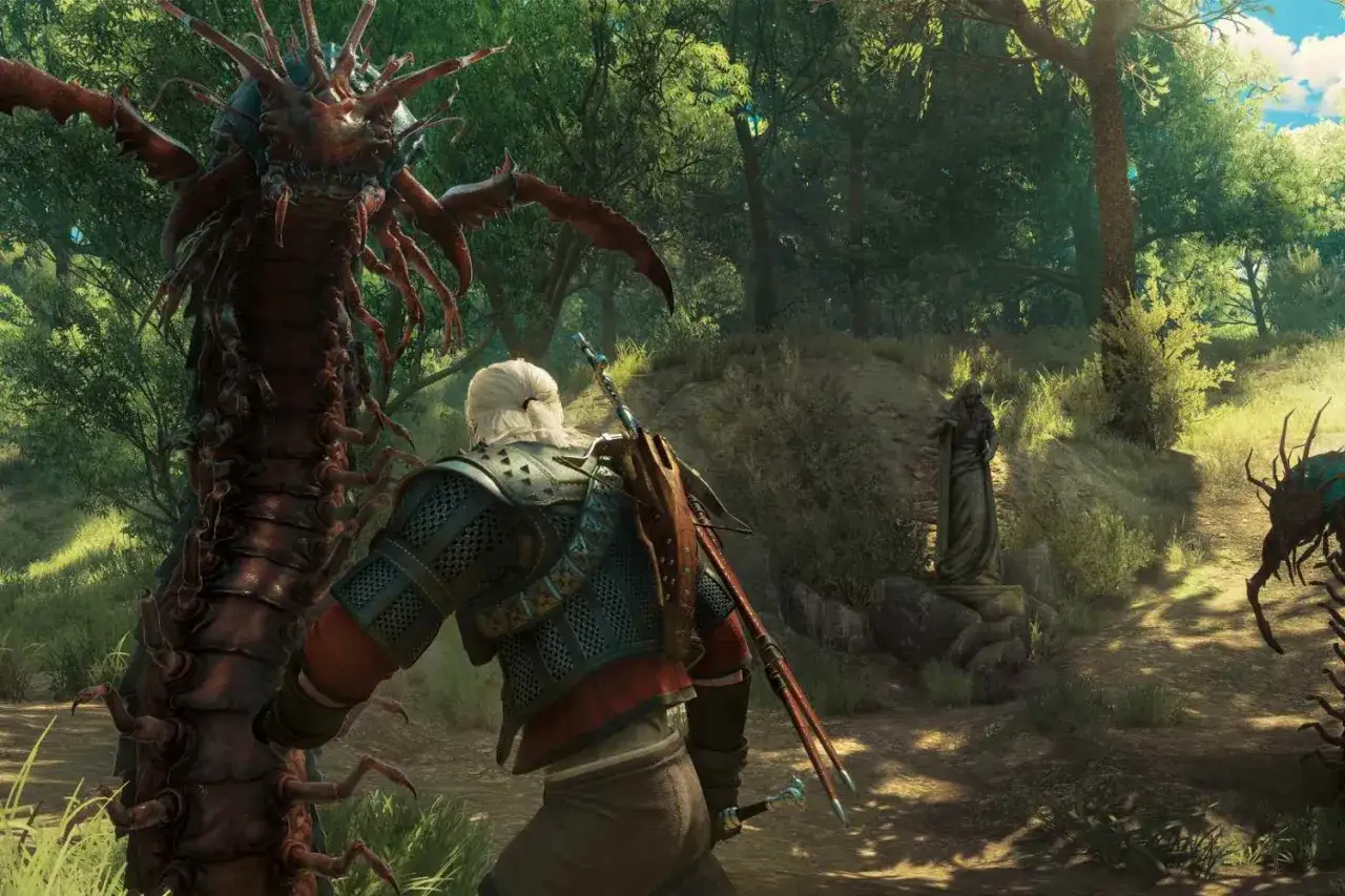 Geralt z Rivii, wiedźmin, staje naprzeciw ogromnego potwora w lesie. W tle widać kamienną rzeźbę i inne stwory.